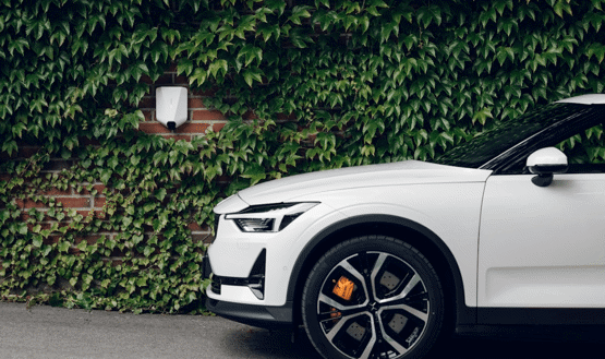 Car parked and charging near wall