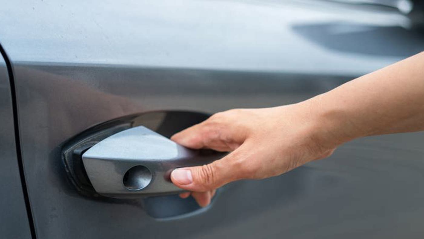 Someone opening the door of a car.
